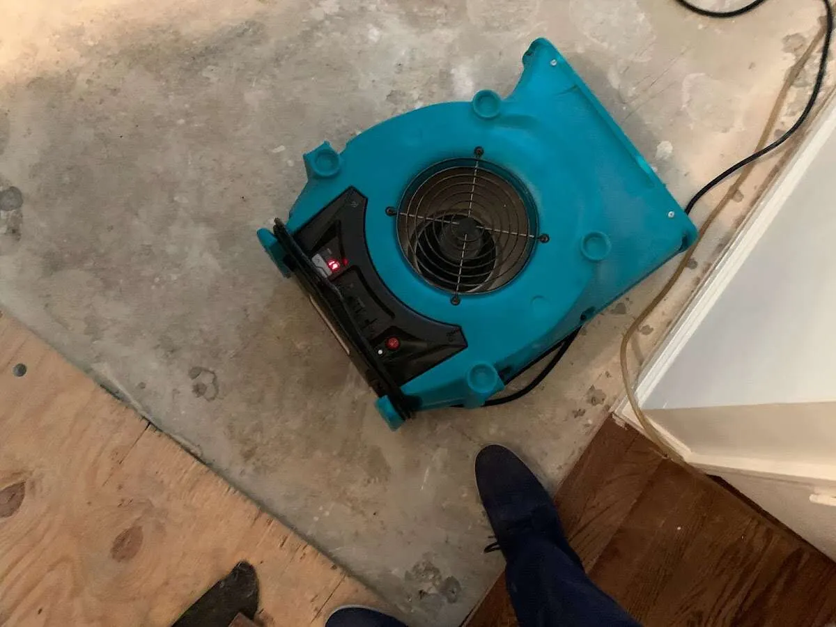 Air mover drying subfloor during Leak Detection & Repair in Leeds